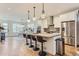 Open concept kitchen with a large center island, stylish pendant lighting and stainless steel appliances at 4170 Vrain St, Denver, CO 80212