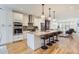 Modern kitchen boasting white cabinetry, stainless steel appliances and a central island with bar seating at 4170 Vrain St, Denver, CO 80212