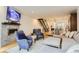 Inviting living room with modern décor, a stylish fireplace, open staircase, and seamless flow to the kitchen at 4170 Vrain St, Denver, CO 80212