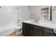 Bathroom featuring a single sink vanity, quartz countertop, and a shower/tub combo at 4543 Cholla Trl, Castle Rock, CO 80104