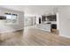 Spacious living area with wood floors, leading to a modern kitchen and staircase at 4543 Cholla Trl, Castle Rock, CO 80104