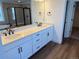 Bathroom featuring double sinks, quartz counters, white cabinets, and a glass shower at 1131 Joseph Pl, Erie, CO 80026