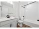 Bright bathroom featuring a white vanity, toilet, and shower-tub combination with dark hardware at 1131 Joseph Pl, Erie, CO 80026