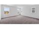 Spacious bedroom with plush carpeting and multiple windows offering neighborhood views at 1131 Joseph Pl, Erie, CO 80026