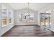 Dining room featuring modern chandelier and three large windows for optimal natural light at 1131 Joseph Pl, Erie, CO 80026