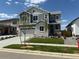 Beautiful two-story home featuring stone accents, manicured lawn, and attached two-car garage at 1131 Joseph Pl, Erie, CO 80026