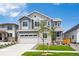 Beautiful two-story home featuring stone accents, a gray exterior, manicured lawn and attached two-car garage at 1131 Joseph Pl, Erie, CO 80026