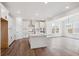 Modern kitchen with white cabinetry, stainless steel appliances, large center island, and open dining area at 1131 Joseph Pl, Erie, CO 80026