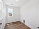 Well-lit laundry room featuring wood-look flooring, a window, and washer/dryer hookups at 1131 Joseph Pl, Erie, CO 80026