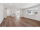 Open concept living room features hardwood floors, large windows, and seamless flow into the kitchen at 1131 Joseph Pl, Erie, CO 80026