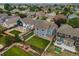Aerial view of the blue home and backyard that is bordered by a white fence at 15378 E 99Th Way, Commerce City, CO 80022