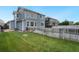 Manicured backyard featuring a wood fence, lush green grass and the exterior of home at 15378 E 99Th Way, Commerce City, CO 80022