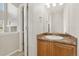 Well-lit bathroom featuring a vanity with warm wood cabinetry, a white sink, and a mirror at 15378 E 99Th Way, Commerce City, CO 80022