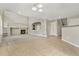 Open living area with carpet, tile flooring, fireplace, built-in shelves, neutral colors, and natural light at 15378 E 99Th Way, Commerce City, CO 80022