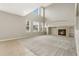 Bright living room with fireplace, built-in shelves, tile flooring, carpet, high ceilings, and large windows at 15378 E 99Th Way, Commerce City, CO 80022