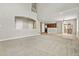 Spacious living area with carpet, tile flooring, open layout, and access to kitchen and outdoor area at 15378 E 99Th Way, Commerce City, CO 80022