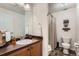Bathroom featuring modern sink, vanity, mirror, and a shower behind a curtain at 10056 W Unser Dr # 204, Littleton, CO 80127