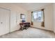 Bedroom with a window view, sliding closet doors, and a desk with a chair at 10056 W Unser Dr # 204, Littleton, CO 80127