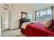 Bright bedroom features a large window and a dark wood dresser at 10056 W Unser Dr # 204, Littleton, CO 80127