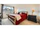 Cozy bedroom with a comfortable bed, side tables with lamps, and large window allowing natural light at 10056 W Unser Dr # 204, Littleton, CO 80127