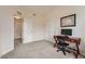 Bedroom with large closet, gray carpet, adjacent to a separate room at 10056 W Unser Dr # 204, Littleton, CO 80127