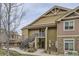 Exterior view of a two-story tan condo complex with stone veneer at 10056 W Unser Dr # 204, Littleton, CO 80127