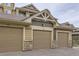 Garage doors for condo units with stone detail at base and beige trim at 10056 W Unser Dr # 204, Littleton, CO 80127