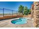 Community hot tub featuring a brick surround and attractive fence with an open view at 10056 W Unser Dr # 204, Littleton, CO 80127