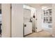 Bright laundry room with stacked washer and dryer and sliding closet doors at 10056 W Unser Dr # 204, Littleton, CO 80127