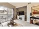 Relaxing living room featuring a sliding glass door to balcony, modern entertainment center with fireplace at 10056 W Unser Dr # 204, Littleton, CO 80127
