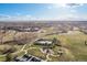 Aerial view of a community park with a playground, tennis courts, walking paths, and open green spaces at 21593 Hill Gail Way, Parker, CO 80138