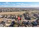 Aerial view of a neighborhood showcasing residential homes, streets, and a blend of urban and natural landscapes at 21593 Hill Gail Way, Parker, CO 80138