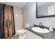 Functional bathroom with vanity, toilet and shower, with decorative brown shower curtain at 21593 Hill Gail Way, Parker, CO 80138