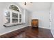 Bright bedroom with window seat, plantation shutters, and rich wood flooring at 21593 Hill Gail Way, Parker, CO 80138