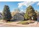 Home's corner lot boasts a large front yard with mature landscaping and attached garage at 21593 Hill Gail Way, Parker, CO 80138