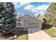 Charming home features a front lawn, attached garage and stone accents at 21593 Hill Gail Way, Parker, CO 80138