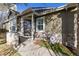 Covered front porch features stone accents, custom storm door and decorative plants at 21593 Hill Gail Way, Parker, CO 80138