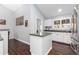 Eat-in kitchen area featuring dark floors and modern island at 21593 Hill Gail Way, Parker, CO 80138