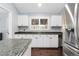 Kitchen with white cabinetry and stainless-steel refrigerator and dark counters at 21593 Hill Gail Way, Parker, CO 80138