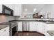 View of a kitchen with stainless steel appliances and white cabinets at 21593 Hill Gail Way, Parker, CO 80138