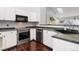 Bright kitchen with stainless steel appliances and white cabinets at 21593 Hill Gail Way, Parker, CO 80138