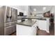 Open kitchen featuring stainless steel appliances, island, and hardwood floors at 21593 Hill Gail Way, Parker, CO 80138