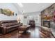 Cozy living room with a stone fireplace, wood floors, and a skylight at 21593 Hill Gail Way, Parker, CO 80138