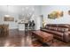 Open floor plan showcases a bar, vaulted ceilings, and hardwood floors at 21593 Hill Gail Way, Parker, CO 80138