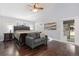 Primary bedroom with a sitting area, wood floors, and ensuite access at 21593 Hill Gail Way, Parker, CO 80138