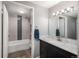 Stylish bathroom with a marble countertop vanity, sleek fixtures, and a tiled shower-tub with decorative inlays at 800 N Pearl St # 1211, Denver, CO 80203