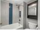 Bathroom features a bathtub with blue herringbone accent tile, rainfall shower head, and vanity mirror at 800 N Pearl St # 1211, Denver, CO 80203