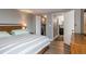 Inviting bedroom boasts hardwood floors, a spacious closet with organized storage, and an adjacent bathroom at 800 N Pearl St # 1211, Denver, CO 80203