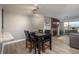 Cozy dining area features a black wood table and chairs next to a brick fireplace and scenic outdoor view at 800 N Pearl St # 1211, Denver, CO 80203