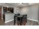 This dining area showcases a black table and chairs with wood flooring and is adjacent to the kitchen at 800 N Pearl St # 1211, Denver, CO 80203
